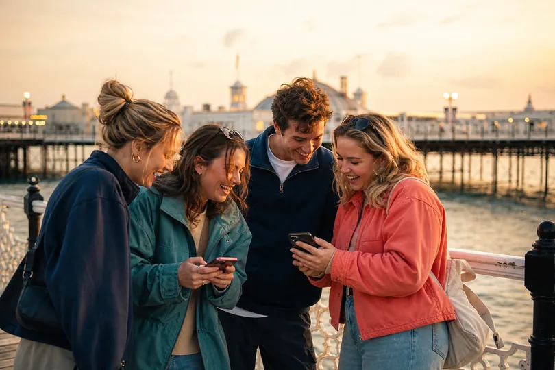 Friends sharing game moments on the pier